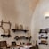 A room displaying Ancient Greek musical instruments, and a man playing a recorder in an adjacent room